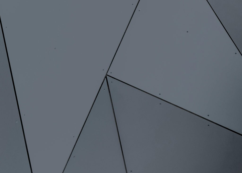 Abstract geometric facade with grey panels and sharp lines in London, Ontario.